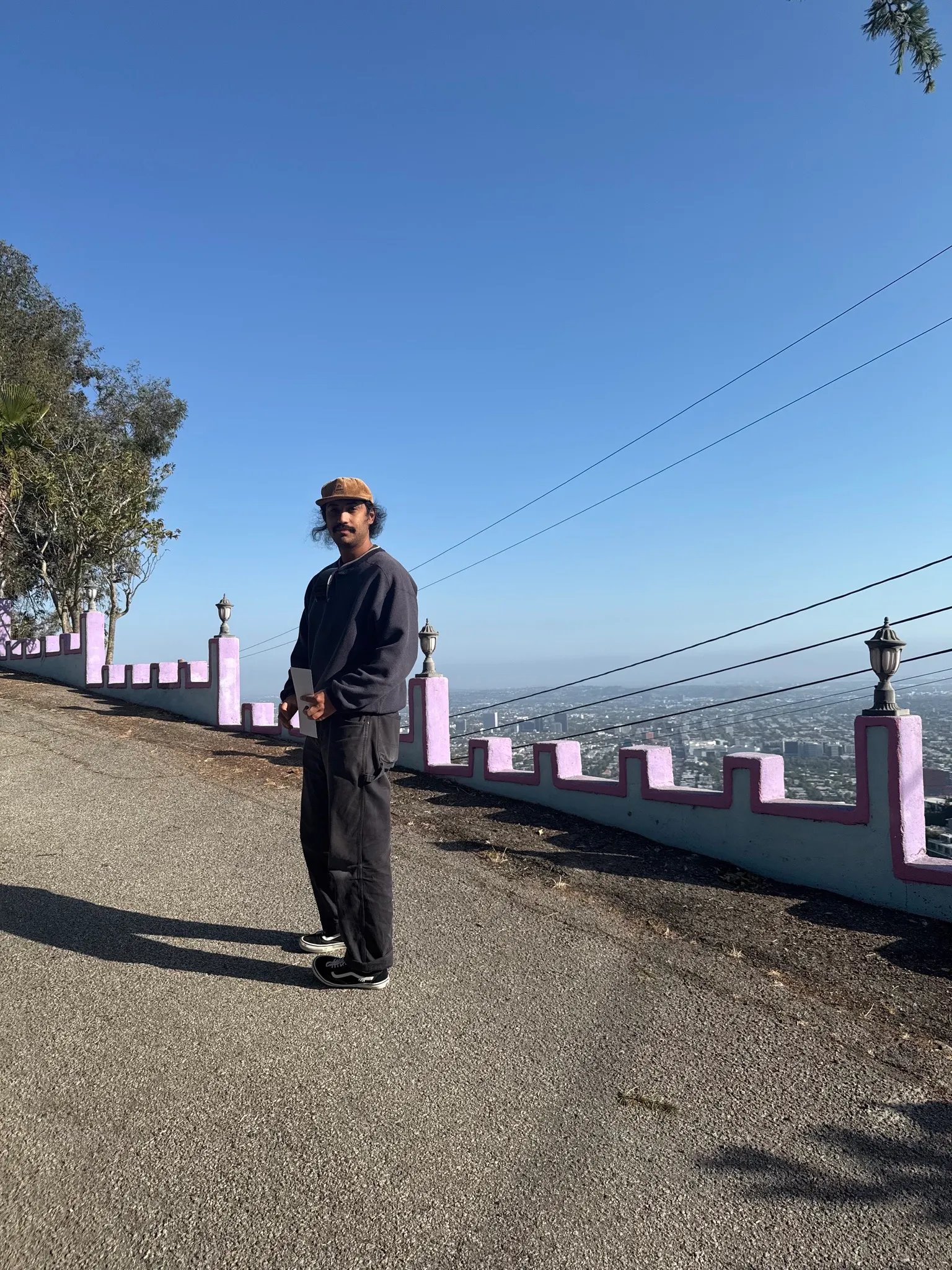 Austin Hunt standing above Los Angeles near a city overlook.